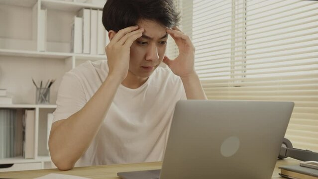 Stressed Young Businessman Facing Financial Loss in Corporate Office, Depressed man Dealing with Financial Setback, Stress and Money Problems, Anxiety and Worry Concept.