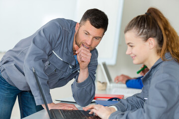 Fototapeta premium students working on car engine classroom