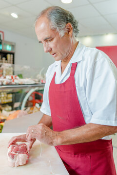 a butcher is preparing meat