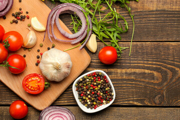 cooking background, home cooking concept. Ripe vegetables, herbs and spices on a wooden background, top view, copy space.
