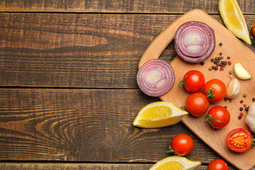 cooking background, home cooking concept. Ripe vegetables, herbs and spices on a wooden background, top view, copy space.