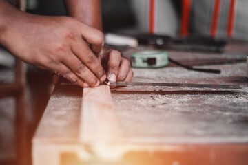 Carpenter working with equipment on wooden table, And measurement of a wooden plank