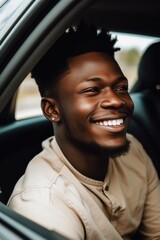 handsome young african man smiling while riding in a car with his family