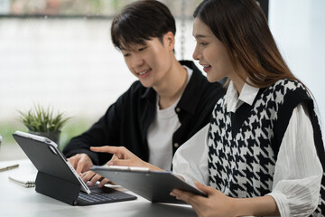 Fototapeta premium Young Asian business team creative businesspeople coworker in office Happy to be successful partnership teamwork success concept.