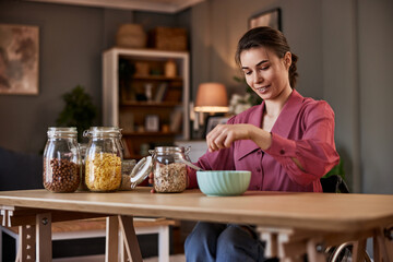 Beautiful woman in a wheelchair making breakfast.