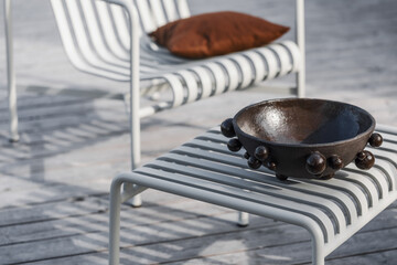 Outdoor patio terrace grey metal furniture on wooden deck. Cozy patio area with garden furniture....