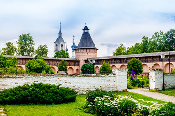 Fototapeta na wymiar Suzdal, Vladimir Oblast, Russia - 5 July 2023: Defensive towers and walls in the apothecary's garden шт Spaso-Evfimiev (Saint Euthymius) Monastery in Suzdal.