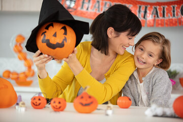 mother and child daughter having fun during halloween