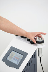 RF body cavitation lifting procedure in a beauty salon. Ultrasound therapy to reduce fat and elasticity of the skin. Cosmetic ultrasonic anti-cellulite massage close-up