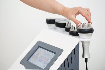 RF body cavitation lifting procedure in a beauty salon. Ultrasound therapy to reduce fat and elasticity of the skin. Cosmetic ultrasonic anti-cellulite massage close-up