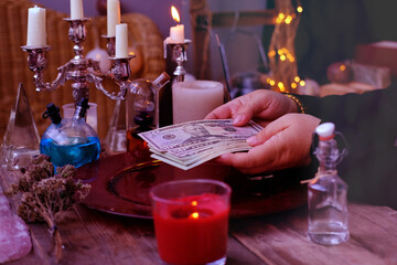 Librate with money, female hands of psychic doing witchcraft passes with dollars, esoteric Oracle...