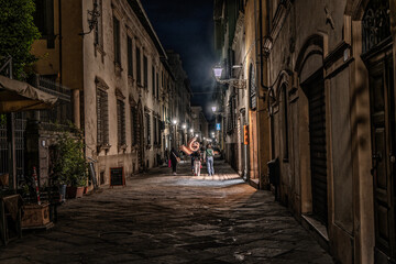 Fototapeta na wymiar Lucca in Tuscany, Small streets at nighttime in Italy