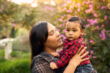 A beautiful Colombian mother with her 1-year-old boy in the nature