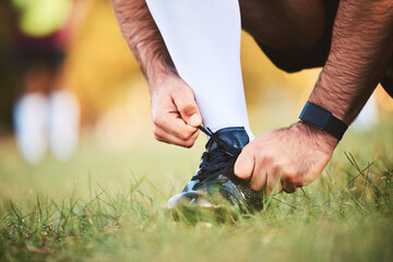 Hands, rugby athlete and tie shoes to start workout, exercise or fitness. Sports, player and man...