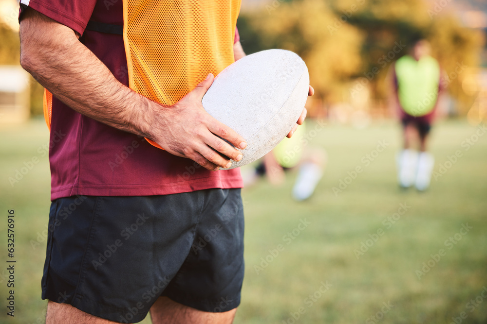 Wall mural Rugby, man and hands with ball for sports games, competition and contest on field. Closeup of athlete, team player and training at stadium for fitness, exercise and performance of challenge outdoor