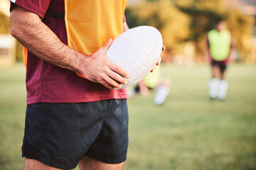 Rugby, man and hands with ball for sports games, competition and contest on field. Closeup of athlete, team player and training at stadium for fitness, exercise and performance of challenge outdoor