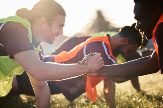 Rugby, handshake and team, exercise and training, cooperation and sunrise. Shaking hands, sports partnership and happy athlete group in agreement, solidarity and workout, fitness and collaboration.