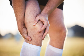 Knee pain, man with injury and fitness accident, athlete outdoor with cramps and muscle tension. Exercise, sports and male person with hands on leg, health crisis and rugby player with inflammation - Powered by Adobe
