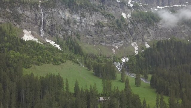 Snow patches and waterfalls, Bi de Sibe Bruenne, sources of the Simme, drone shot, Lenk, Bern, Switzerland, Europe