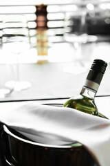 Bottle of wine in an ice bucket on the blurred background served in a restaurant