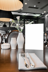 Served table in restaurant with empty mockup menu for advertising text and design