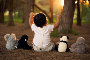 One-year-old baby in a park during the sunset