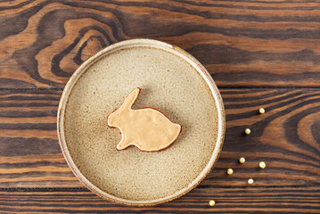 Homemade gingerbread in the form of a rabbit with honey, cinnamon and spices in a bowl.