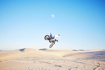 Desert, motorbike jump or sports person travel, agile or driving on off road adventure, air freedom...
