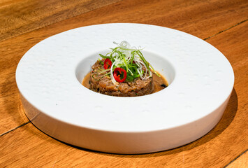 Exquisite dish of tartar. The harmonious arrangement of flavors and textures reflects the artistry of gourmet cuisine, making it a visual and sensory masterpiece.  Close up photo, selective focus.