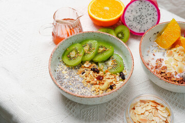 Bowls of oatmeal with mixed fruits topping