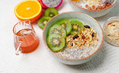 Bowls of oatmeal with mixed fruits topping