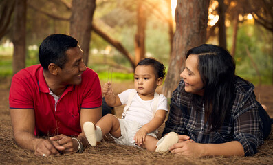 A beautiful family in a park with a one-year-old child