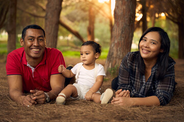 A beautiful family in a park with a one-year-old child