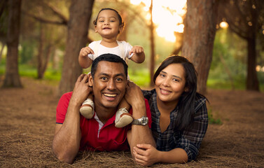 A beautiful family in a park with a one-year-old child