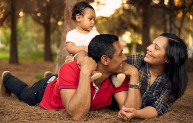 A beautiful family in a park with a one-year-old child