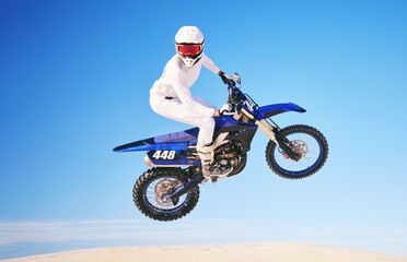 Fototapeta na wymiar Blue sky, motorbike in air and person with action and extreme sport, speed outdoor and mockup space. Adventure, fitness and training, motorcycle jump stunt and freedom, challenge and performance