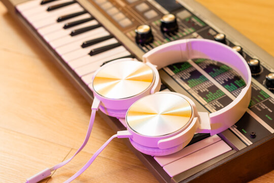 white headphone on synthesizer keyboard. music background