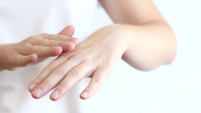 Hand cream. Apply hand cream to the skin with massage movements, close-up. Anti-aging cosmetics. Women's hand care