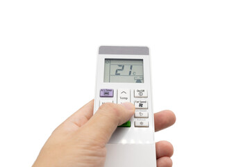 Hand holding air conditioner controller with buttons and display on isolated background.