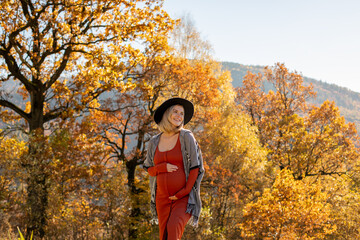 Pregnant healthy walk at sunny autumn day