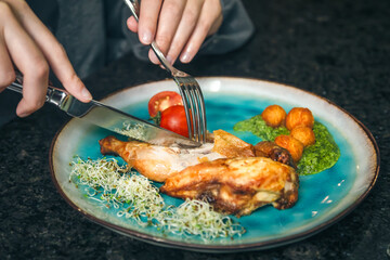 Chicken with vegetables on a plate in a cafe.