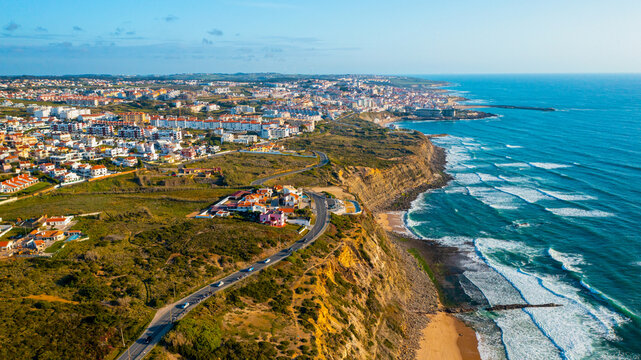 Drone aerial view over beaches, coastlines in Ericeira, Portugal, on summer sunny day. Aerial view to the Beautiful European touristic town. Beautiful cityscape with skyline, ocean rocky shore. Travel
