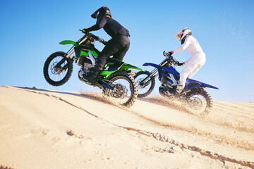 Motorcycle, desert dune and fast in race, contest or outdoor hill climb for performance, goal or off road. Motorbike athlete, launch or ramp in nature, sand or speed for training in summer sunshine