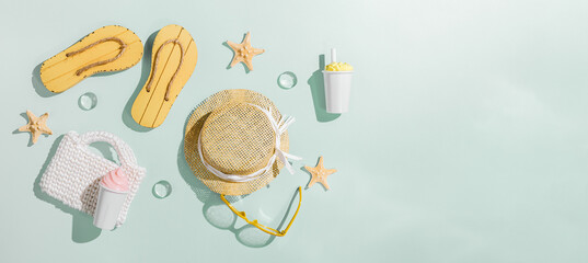 Summer flat lay banner with beach accessories, sunglasses, sun hat, beach shoes sandals,ice cream, white bag, top view on mint background, copy space. Summer vacation concept, aesthetic minimal
