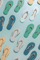 Summer flip flops flat lay, minimal repeat pattern, set of beach footwear vivid colored, top view still life with womans slide sandals, many shoes, summer beach holiday concept, shadow sunlight