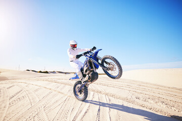 Sand, motorbike balance and sports person doing trick, skill or stunt on off road challenge,...