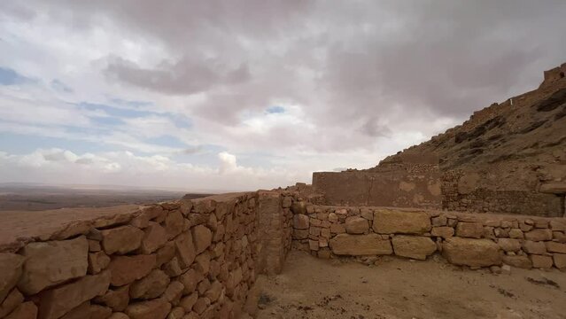 Panoramic view of Ksar Guermessa troglodyte village in Tunisia with cloudy dramatic sky