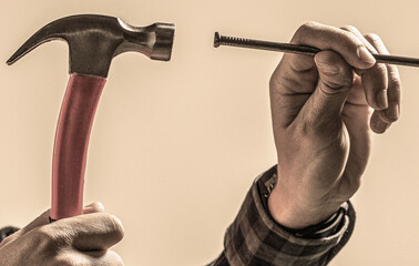 Hands with hammesr and nail. Hammering a nails, hands only. Hammer hand nail