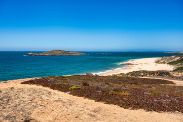Pessegueiro Island on the Alentejo coast of Portugal. Scenic view of the island with its rocky shores and the turquoise Atlantic Ocean.