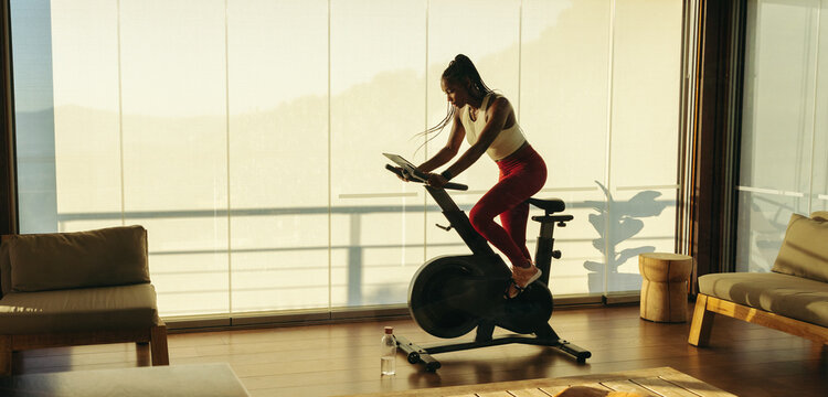 Athletic Black Woman Exercising With Fitness Equipment At Home